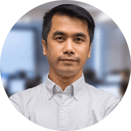 Asian business man smile and standing at computer room blur background